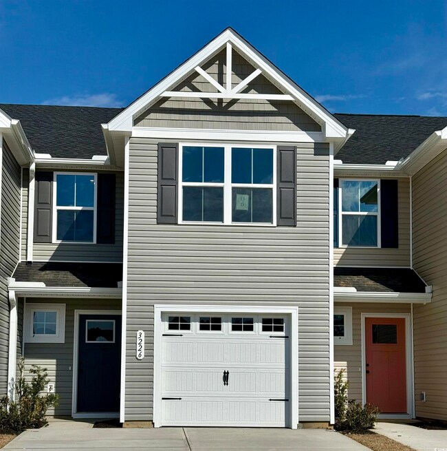 Townhome / multi-family property featuring a garag
