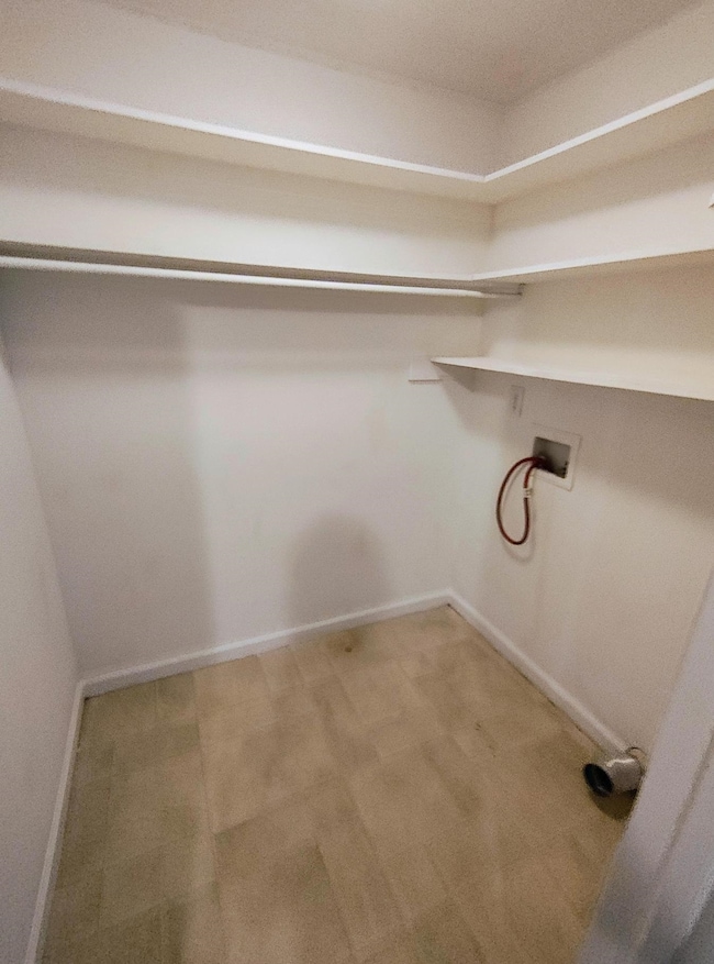 Washroom featuring washer hookup and baseboards