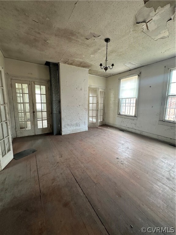 Unfurnished living room with wood-type flooring, f