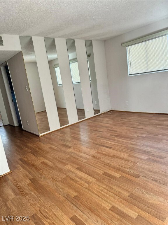 Unfurnished room with wood finished floors, health