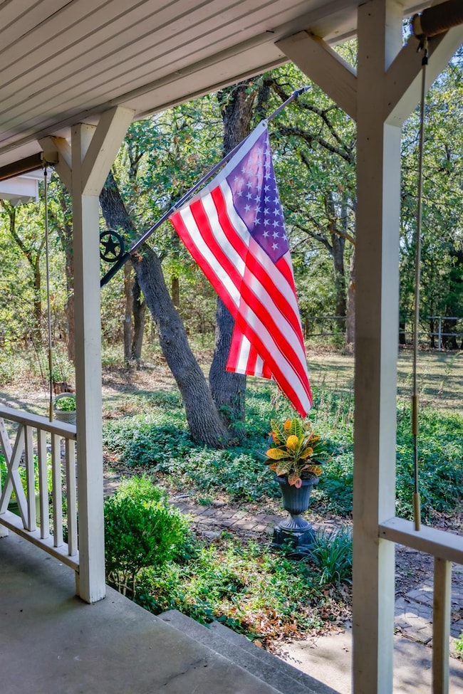 Idyllic front porch even offers porch shades for t