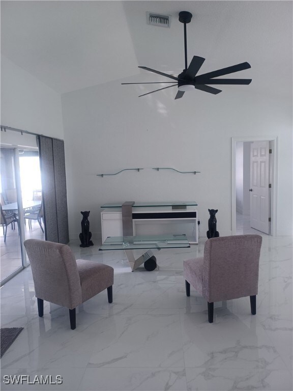 Living area featuring marble finish flooring and a