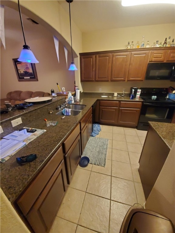 Kitchen featuring black appliances, light tile pat
