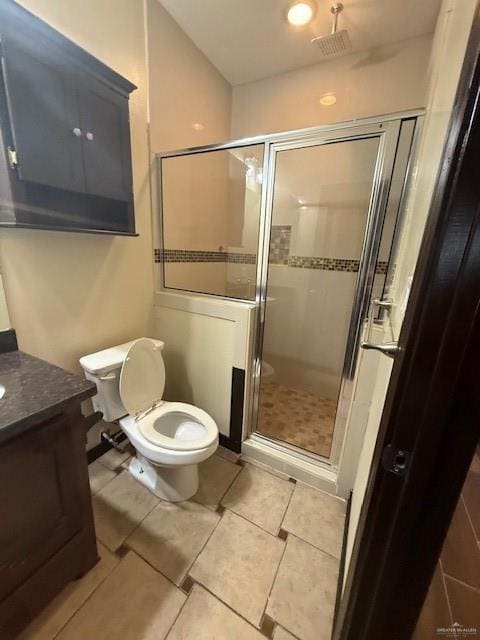 Full bathroom with toilet, a shower stall, vanity, and tile patterned floors
