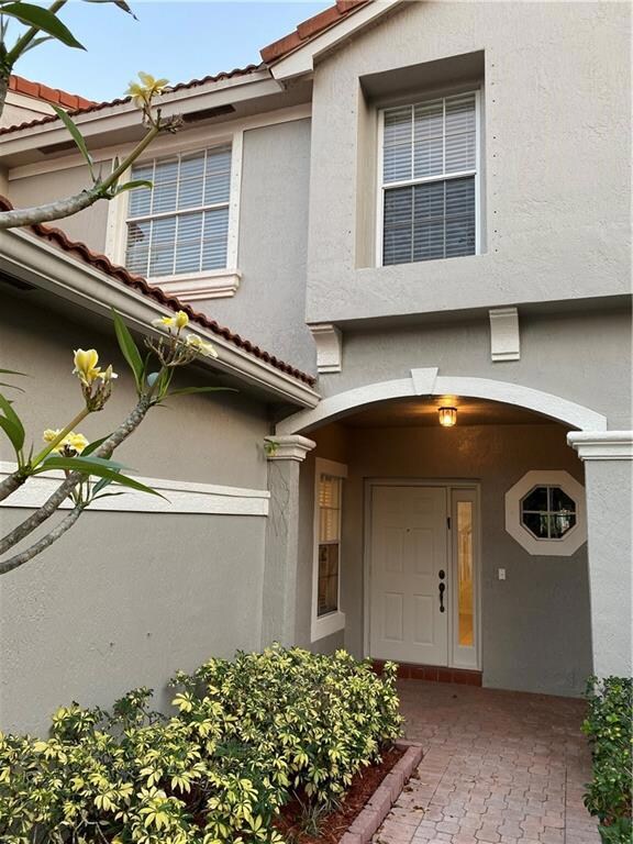 Covered porch entrance with picture window