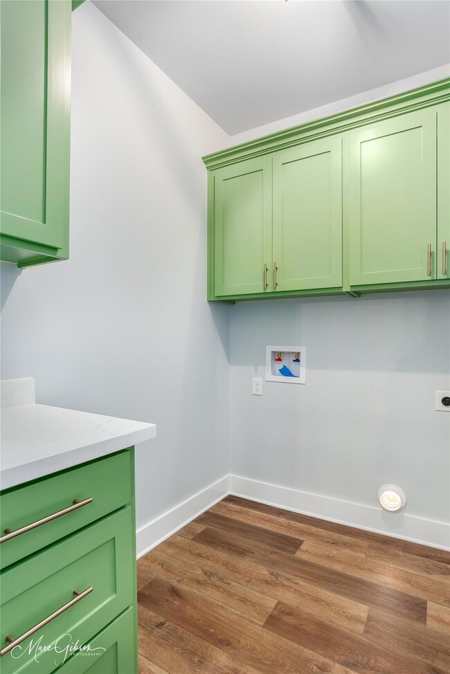 Laundry area featuring dark hardwood / wood-style 