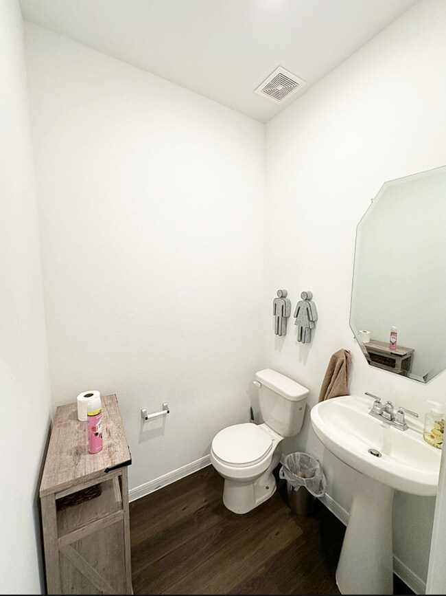 Guest half bathroom beside front door.