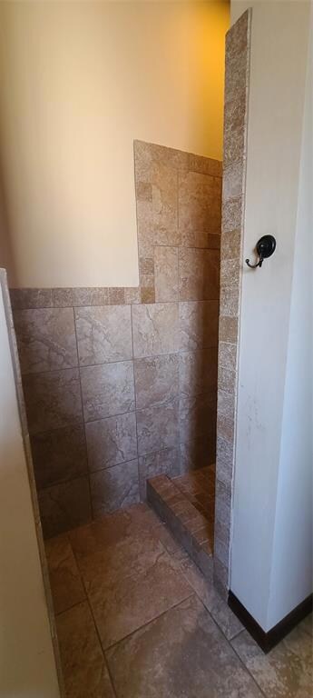 Bathroom with tile flooring and walk in shower