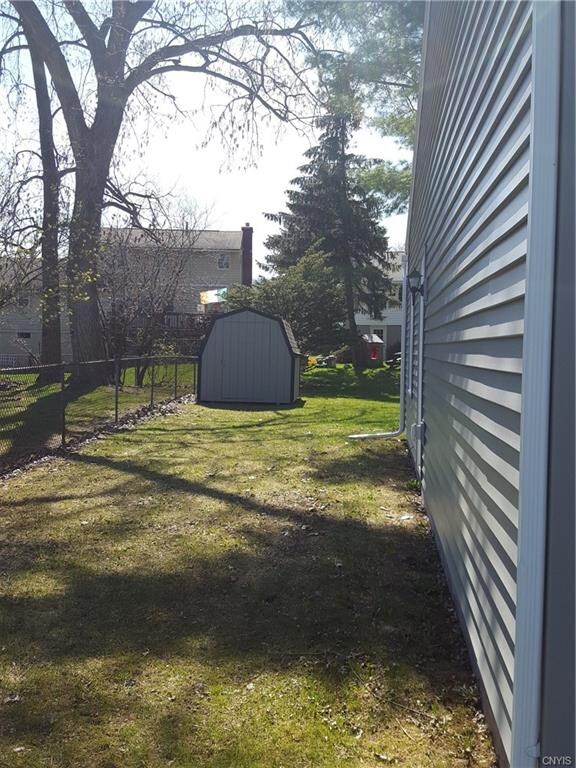 Shed for storage and partially fenced backyard