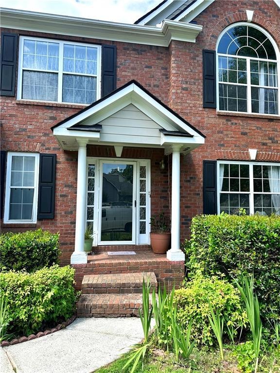 Doorway to property with brick siding