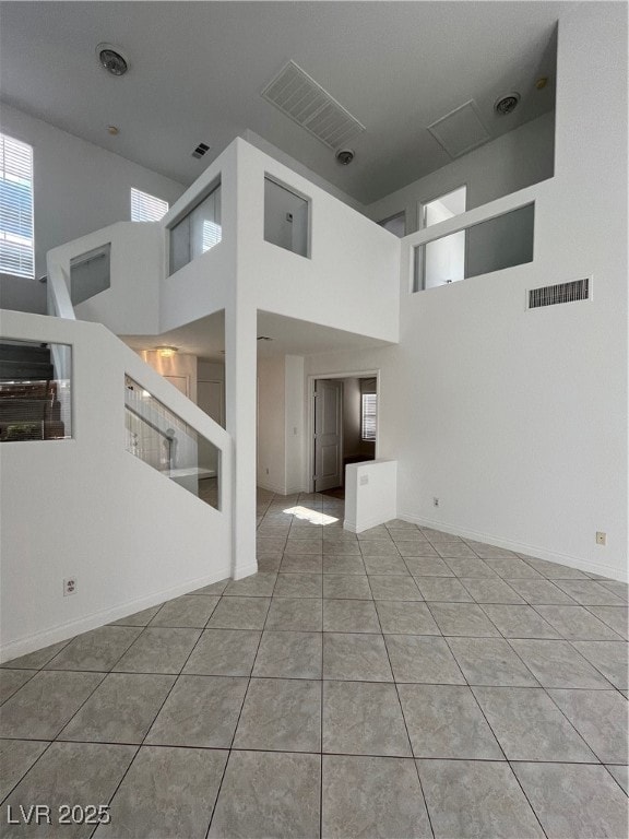 Unfurnished living room with visible vents, a towe