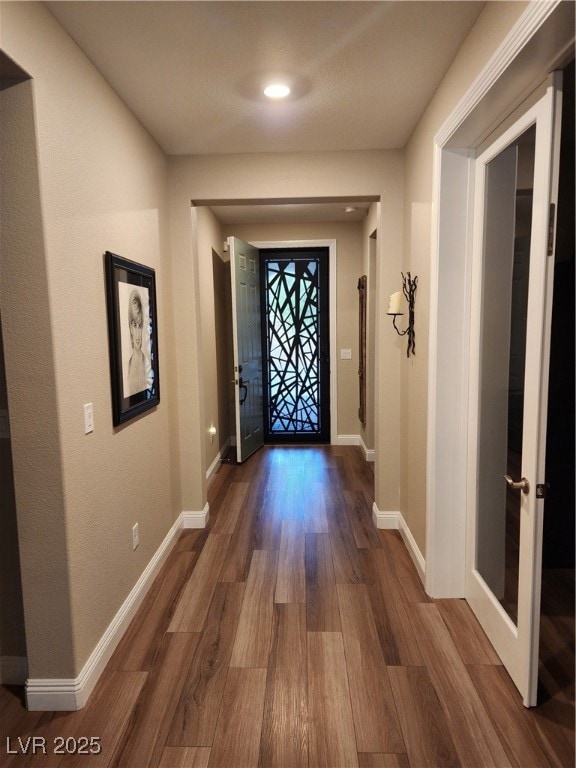 Doorway with Luxury Vinyl floors and recessed lighting