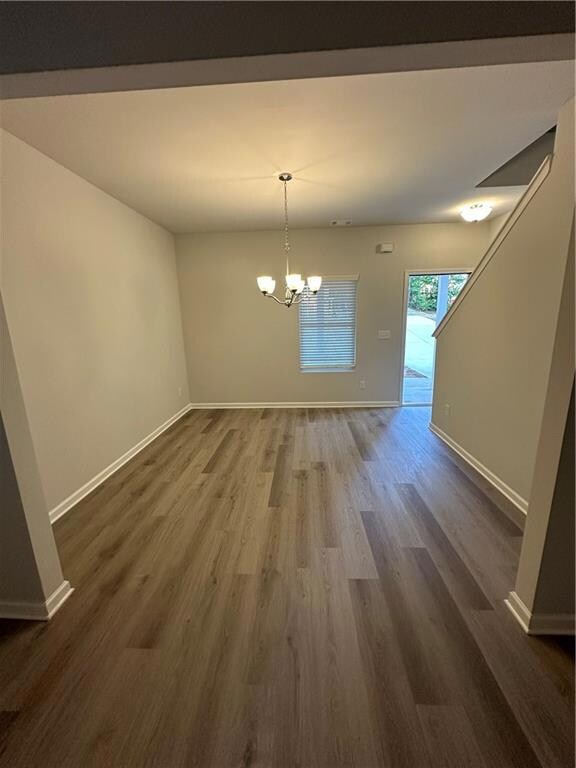 Unfurnished dining area with dark hardwood / wood-