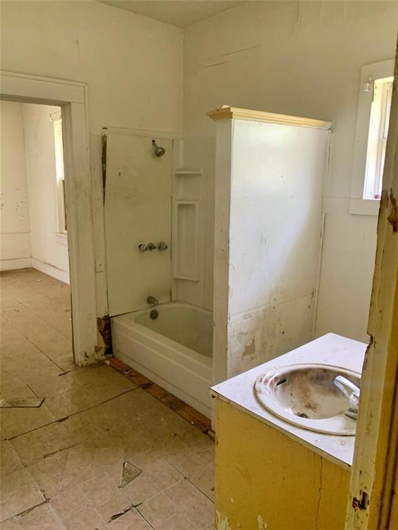 Bathroom featuring tile patterned floors and sink