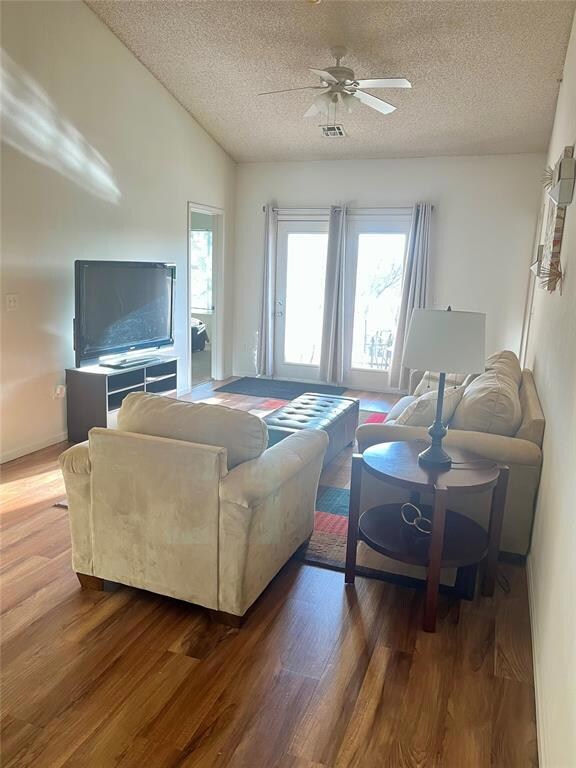 Living area featuring wood finished floors, visibl
