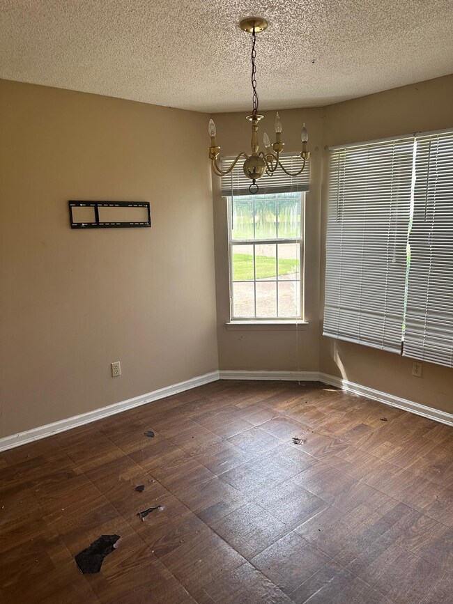 Unfurnished dining area featuring a textured ceili