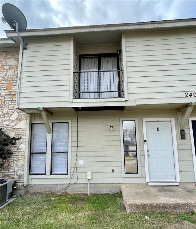 Back of property featuring a balcony