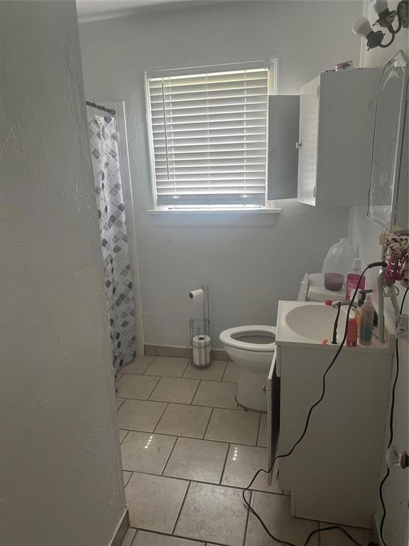 Bathroom featuring vanity, toilet, tile patterned flooring, and a shower with shower curtain