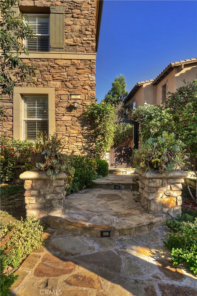 Entrance towards your new home! Gorgeously landscaped front and back with fruit trees galore!