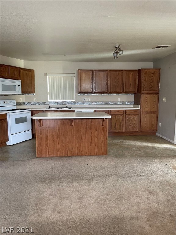 Enter into living room with open concept kitchen.