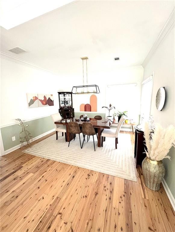 Living area with light wood finished floors and crown molding