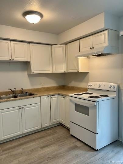 Kitchen featuring white electric range, white cabinetry, light wood-style flooring, and a textured ceiling