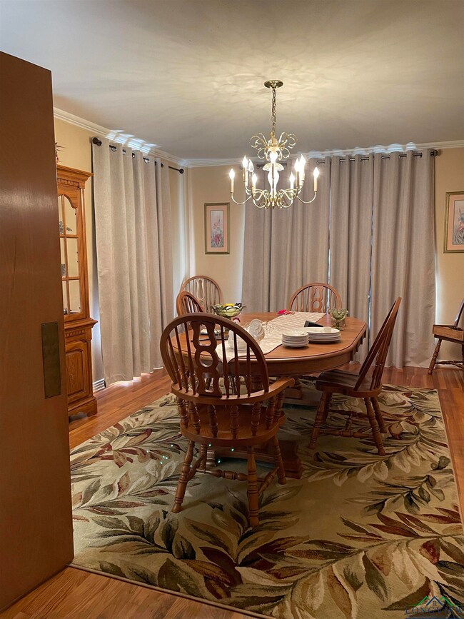 Dining room featuring crown molding, a chandelier,