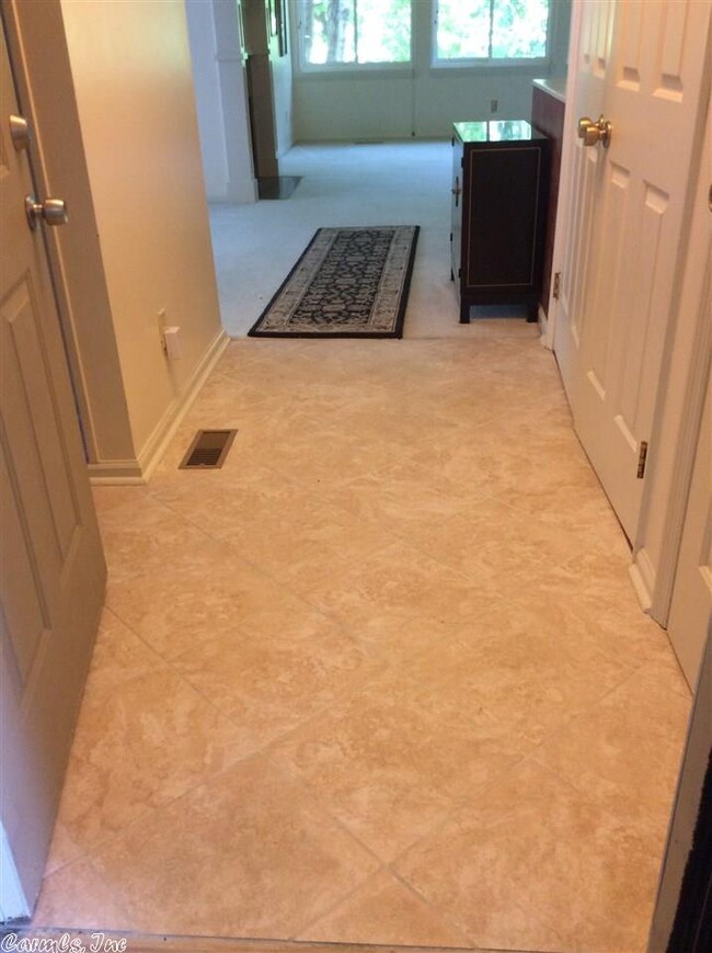 Tile entry opens to living, with kitchen to right
