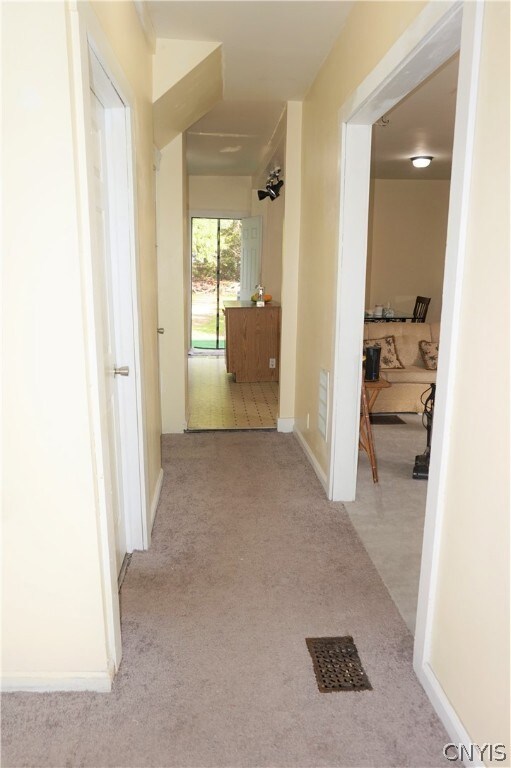 Just inside, the main hallway connects the entire