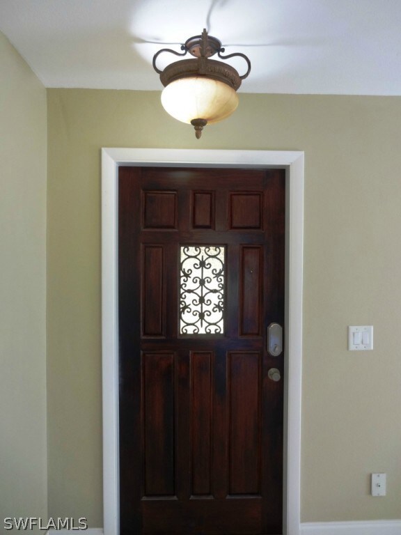 The beautiful wood front door with ornate inset.