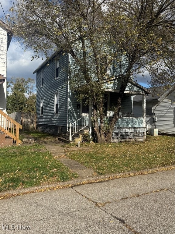 View of front of property with a front lawn and a deck