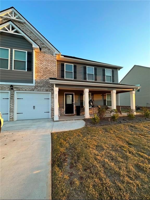 View of front of home featuring a porch, a garage,
