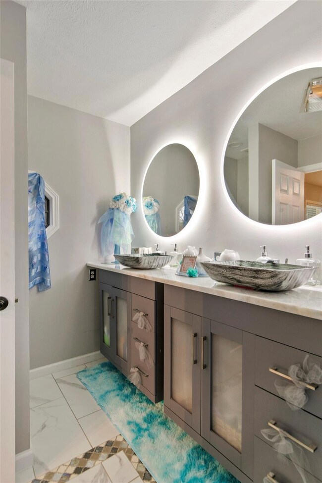 Bathroom with backlit miirrors