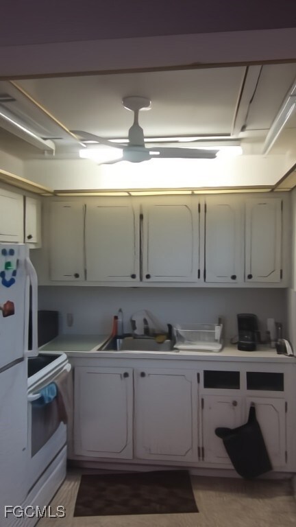 Kitchen with white range with electric stovetop, l