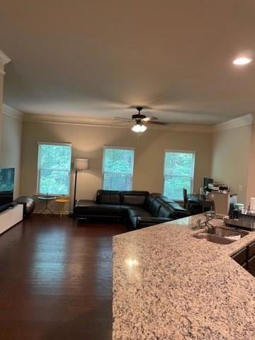 Living room with ornamental molding, a ceiling fan, dark wood-style floors, and recessed lighting