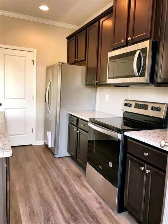 Kitchen featuring crown molding, stainless steel a