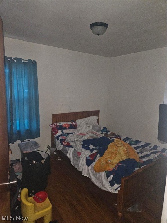 Bedroom featuring dark wood-type flooring