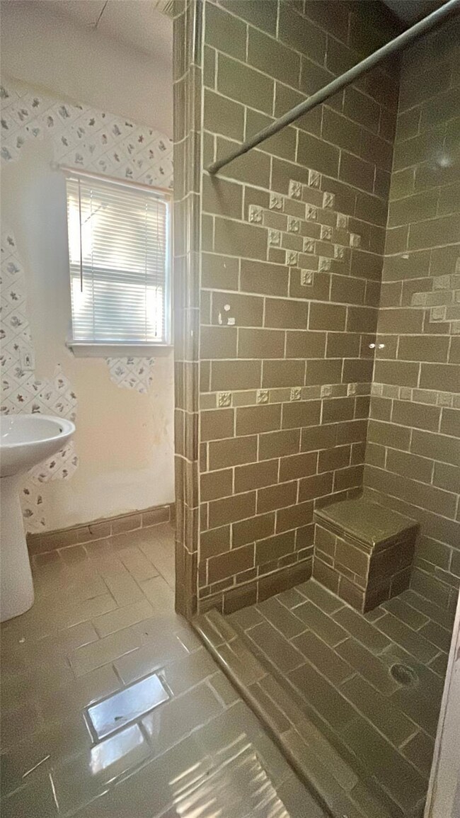 Bathroom featuring tile patterned floors and tiled