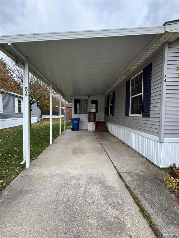 View of parking featuring a carport