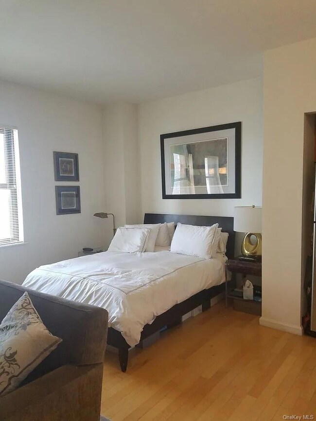 Bedroom with wood finished floors and baseboards