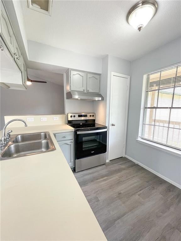 Kitchen with stainless steel electric stove, ligh
