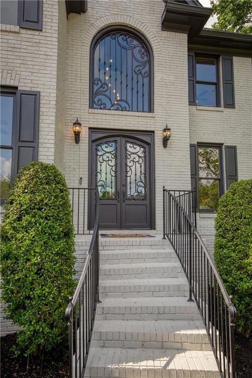 Elegant front entry with wrought iron double doors