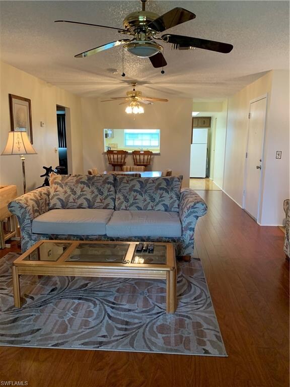 Living room looking into kitchen...beautiful newer flooring.