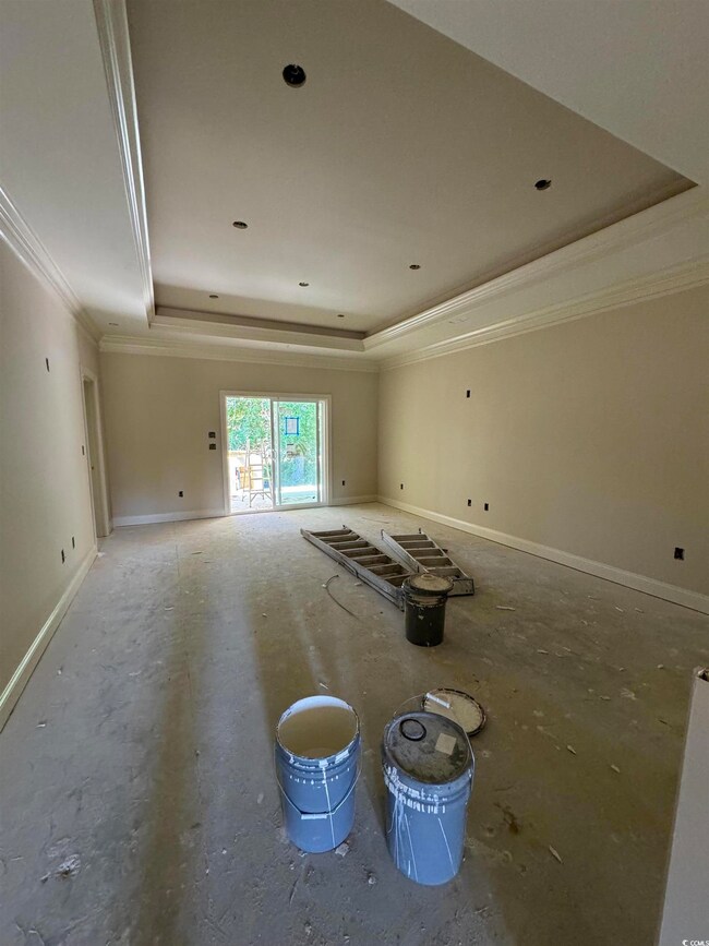 Empty room with a tray ceiling and crown molding