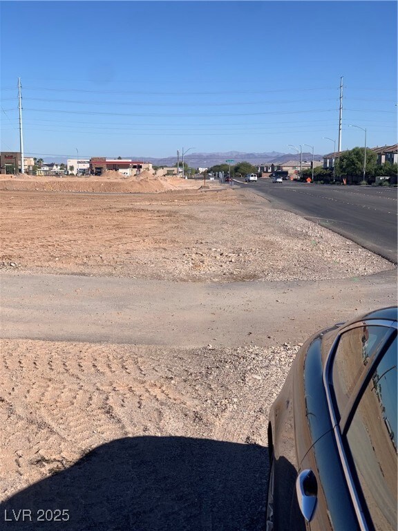 View of asphalt street featuring street lighting