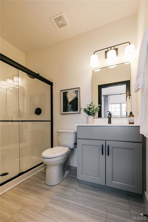 Bathroom featuring vanity and a shower stall