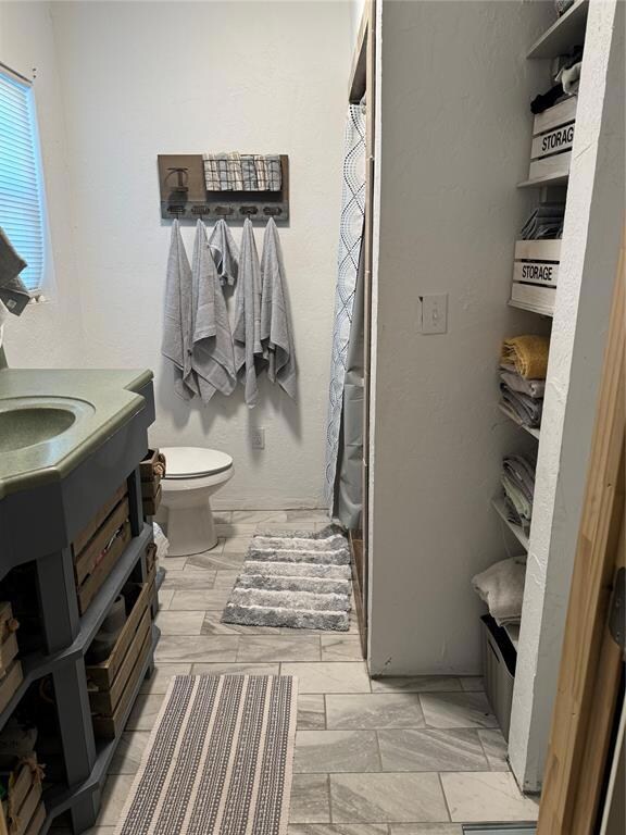 Bathroom with vanity, toilet, and walk in shower