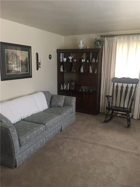 Living room with hardwood floors under the wall to