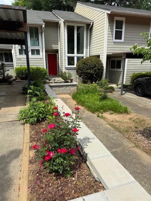 View of front of house.   Roses and Hostas in bloo