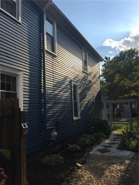 View of a side shared walkway, radon vent & landsc